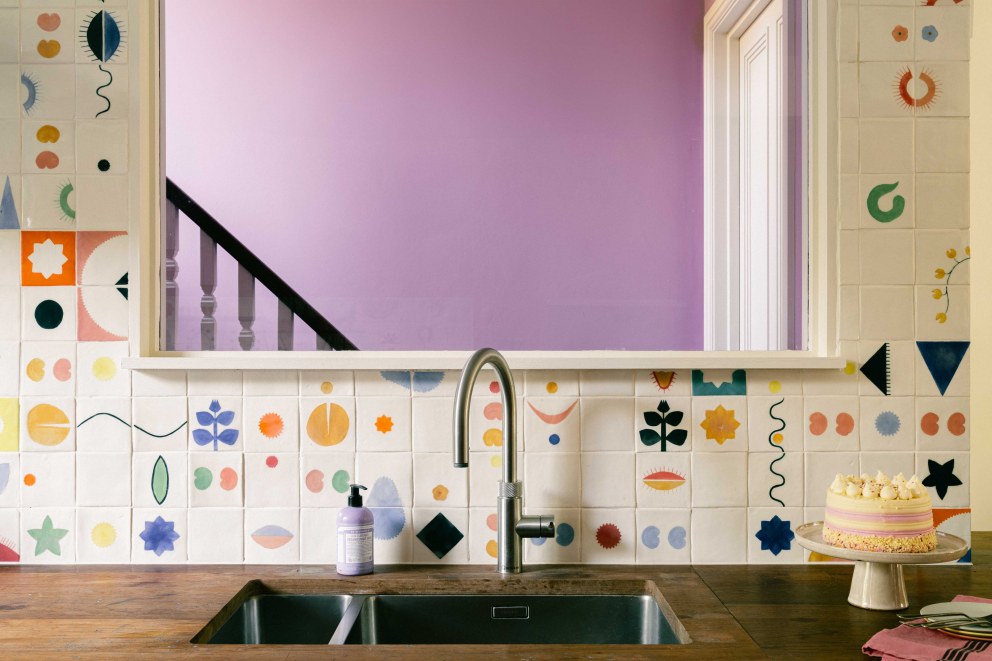 Victorian Terrace, Waterloo | Bespoke kitchen wall tiles looking out onto a vibrant pink landing space | Interior Designers